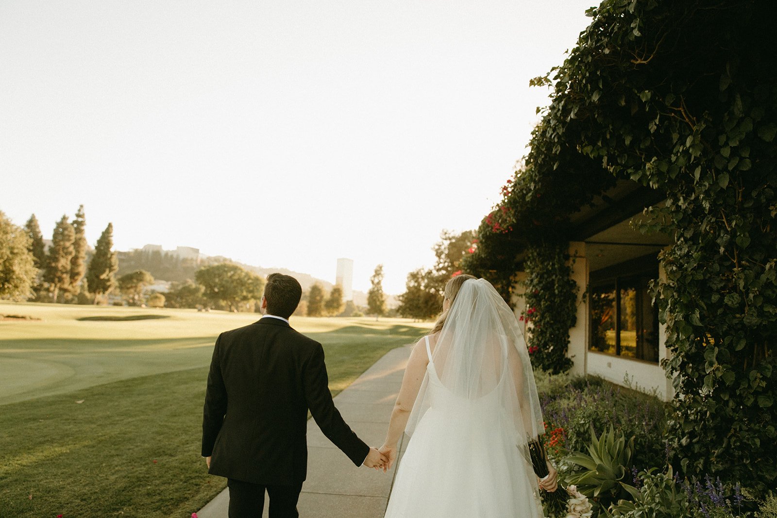 Bride and groom walking into the distance at Lakeside Golf Club