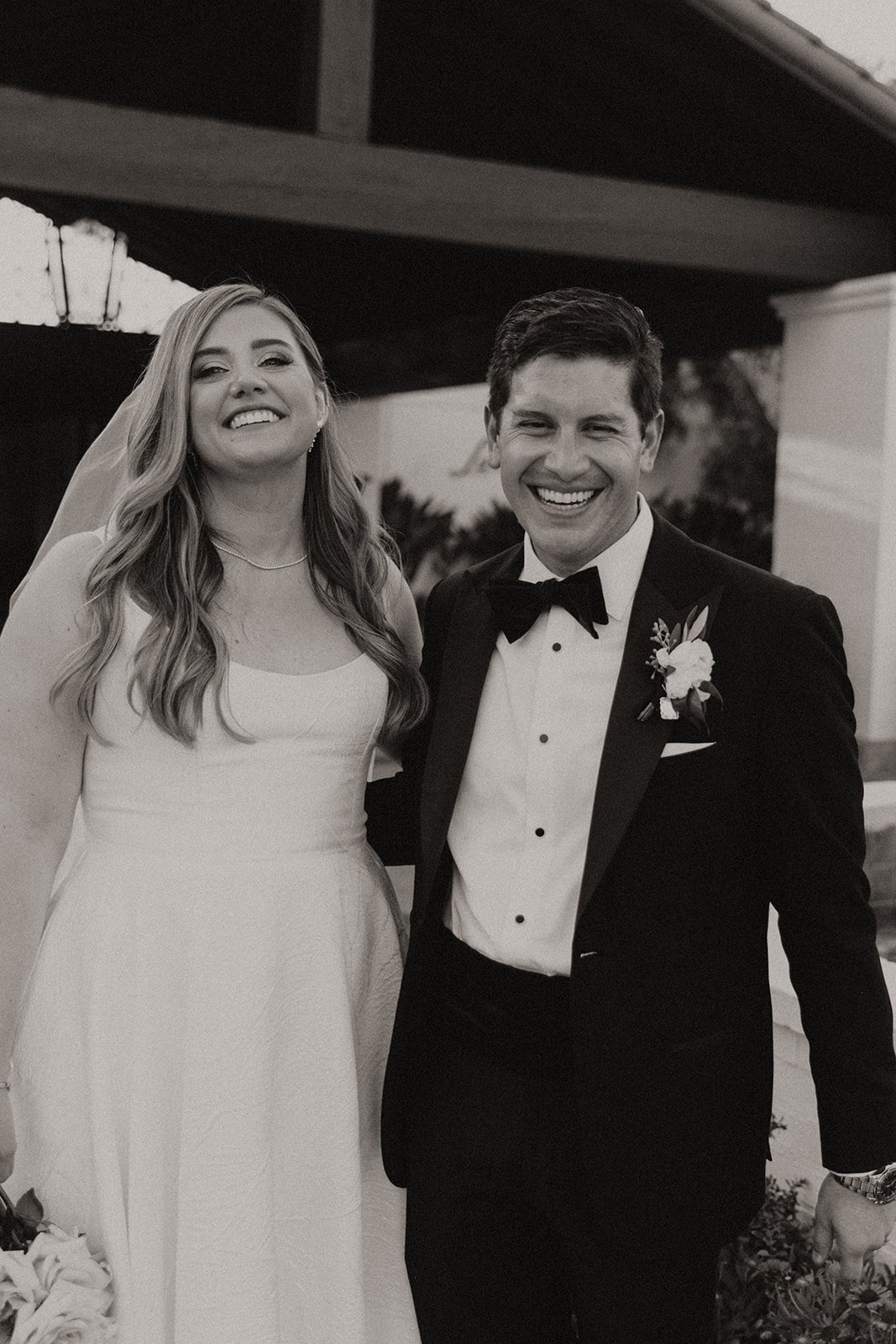 Black and white photo of bride and groom smiling and laughing