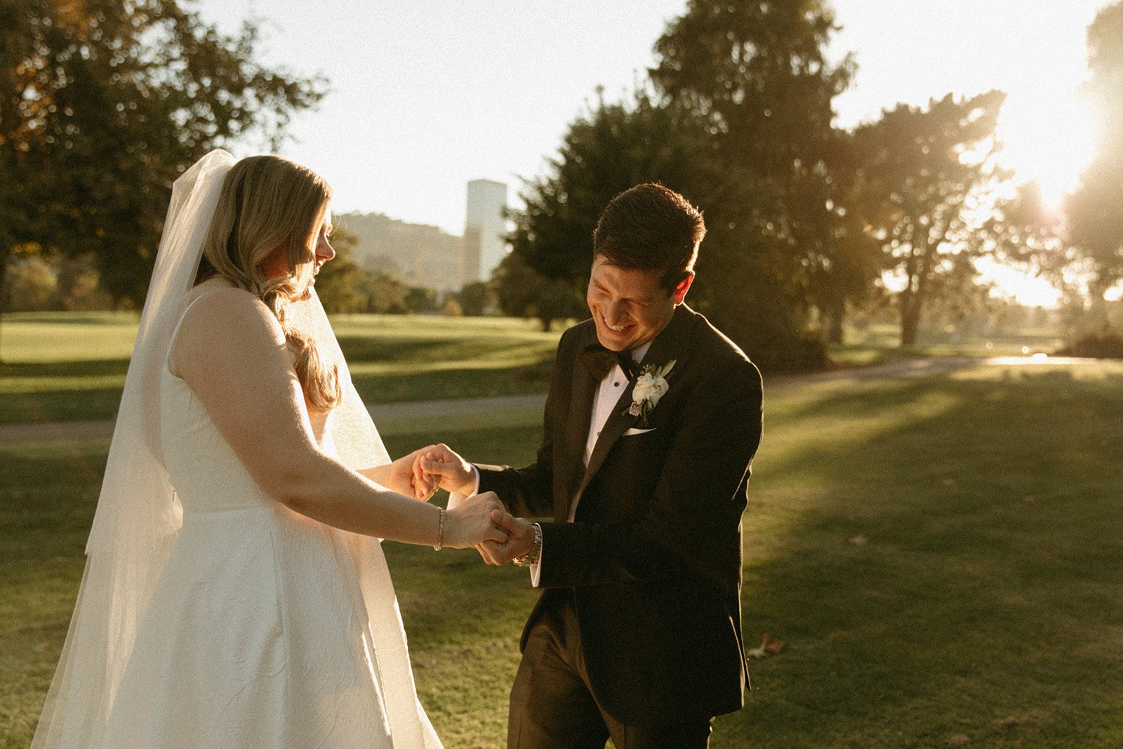 Bride and groom laughing during sunset