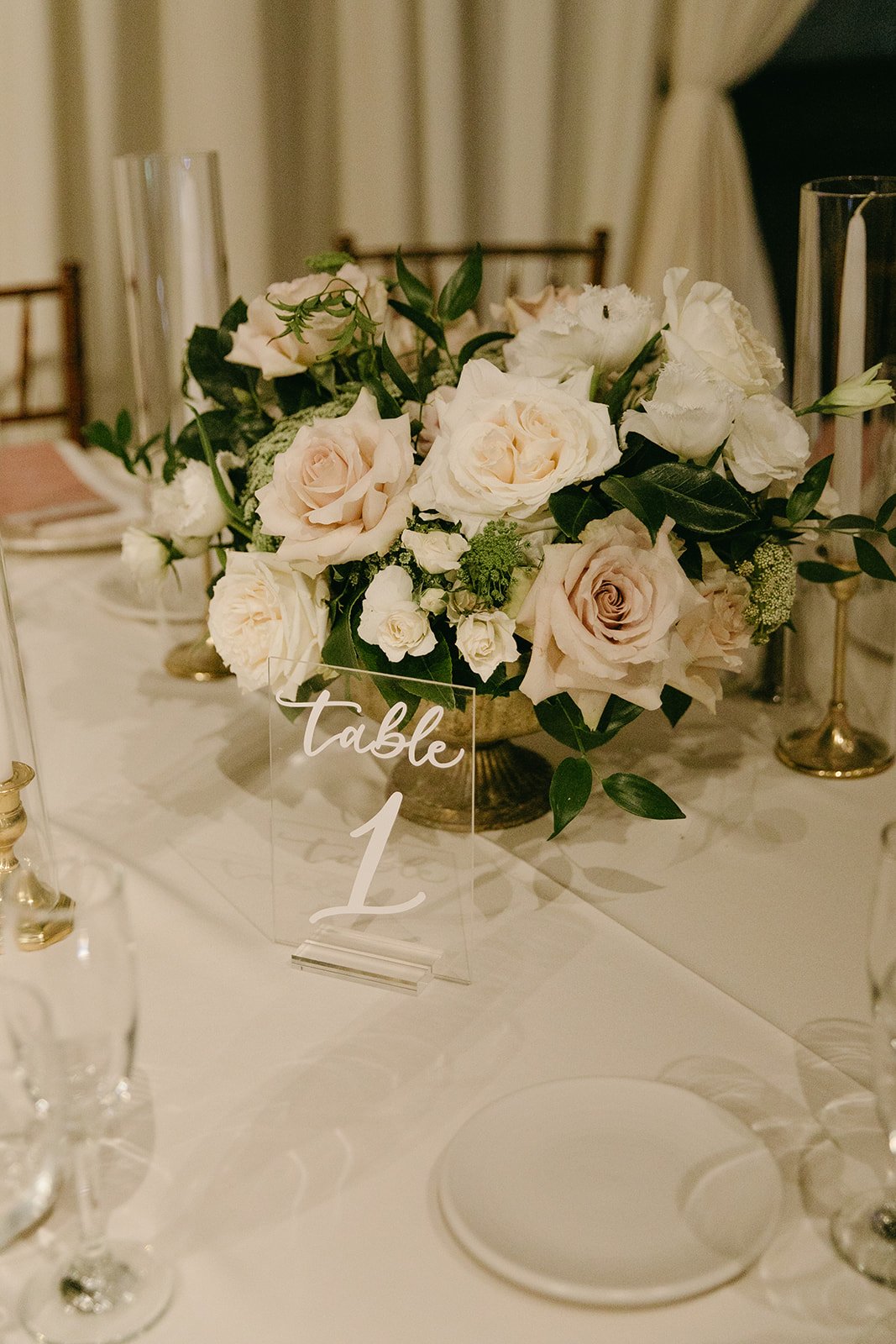 Romantic wedding reception details and floral arrangements