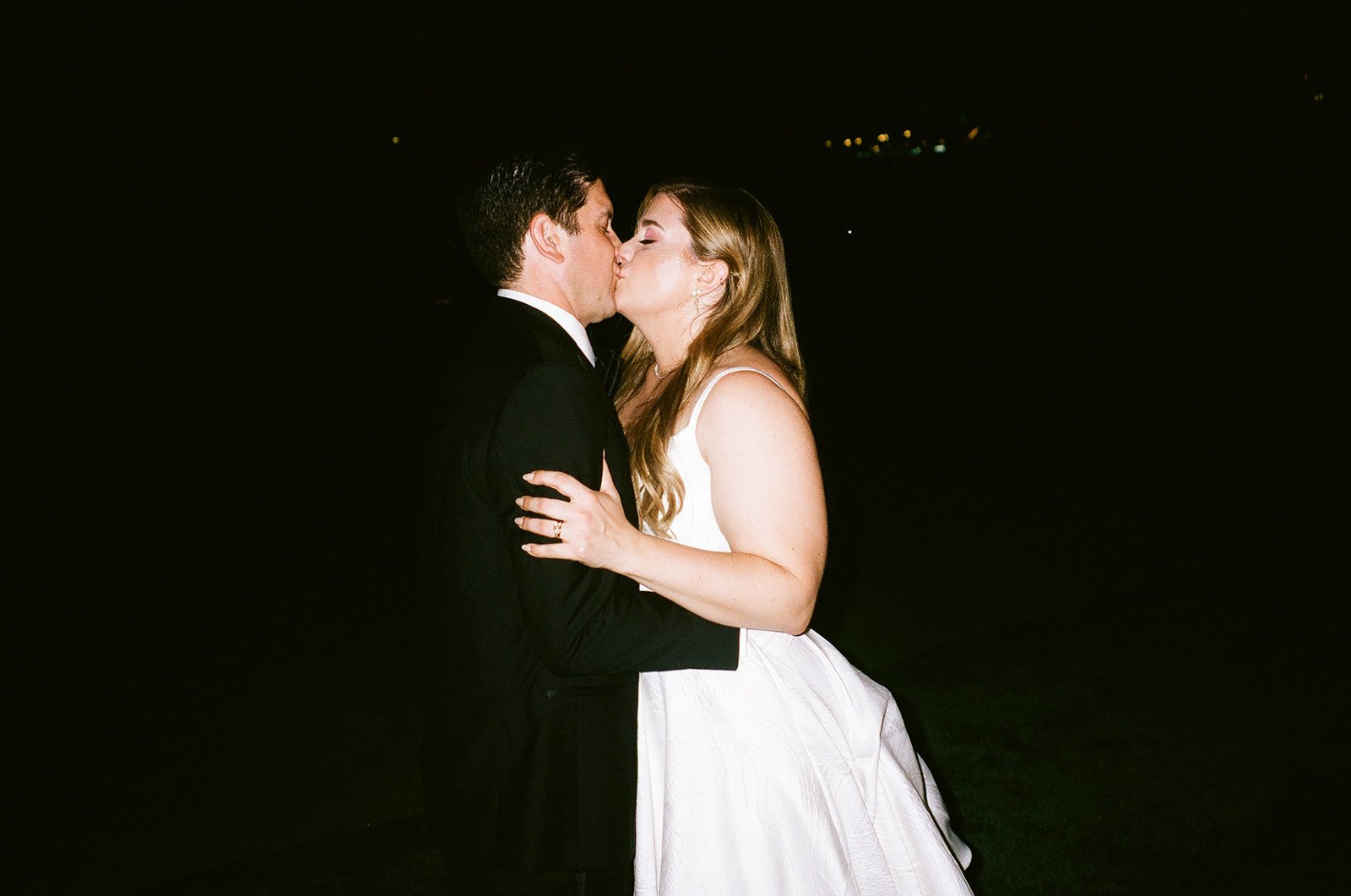 Bride and groom kissing on film