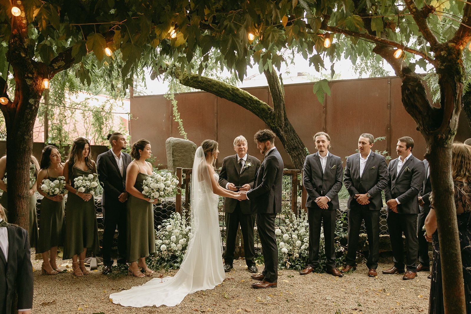 Bride and groom exchanging vows in their outdoor ceremony