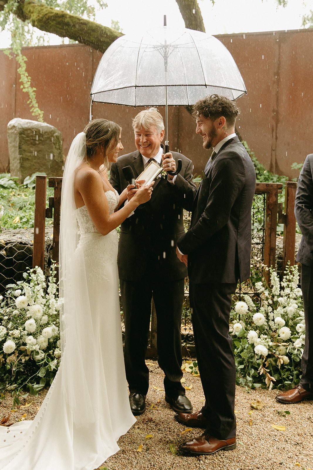 Bride and groom exchanging vows in the rain