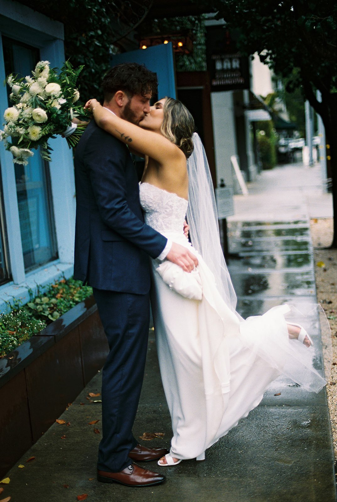 Film photos of bride and groom kissing