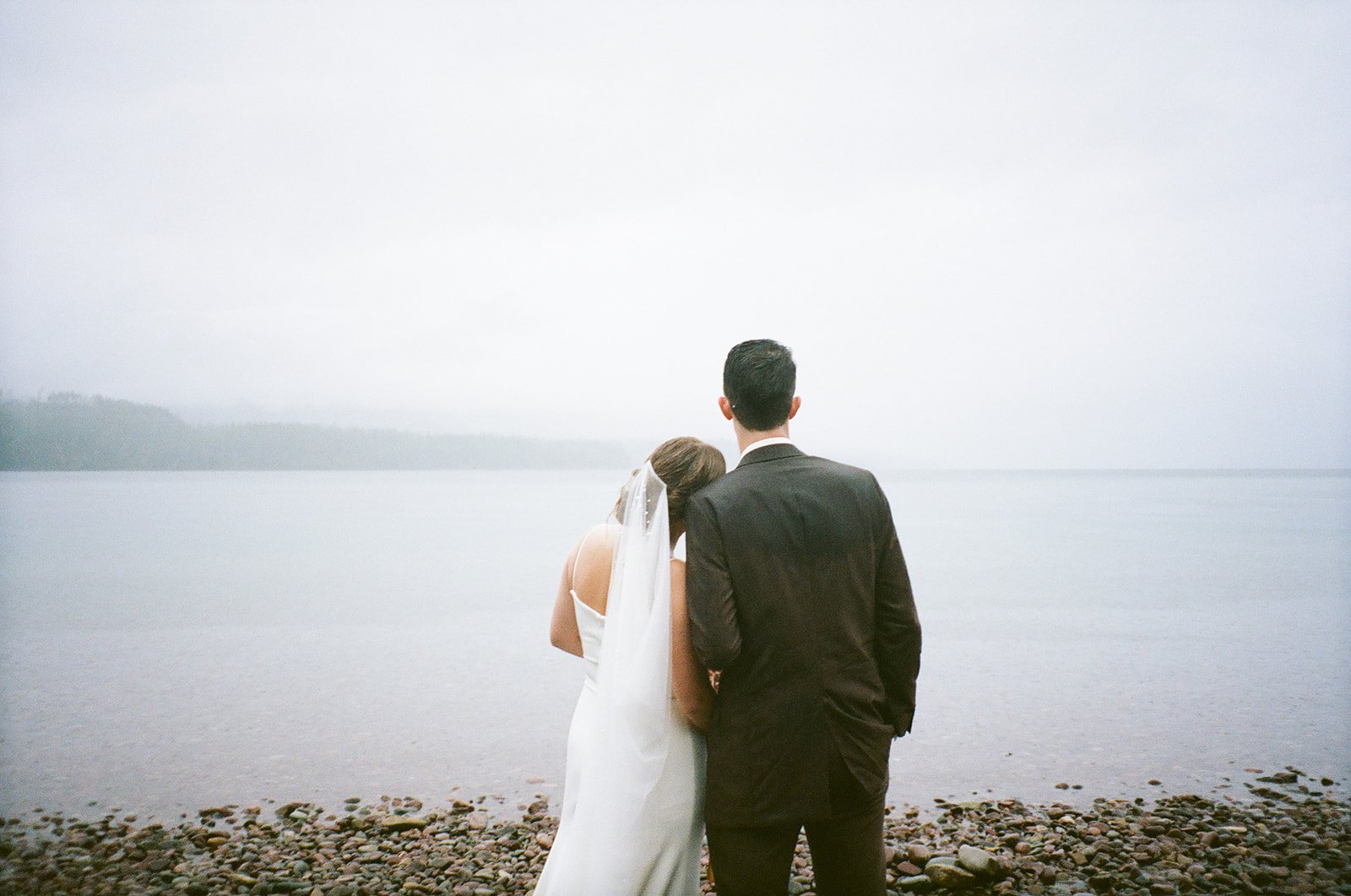 Film photos of bride and groom looking off into the distance