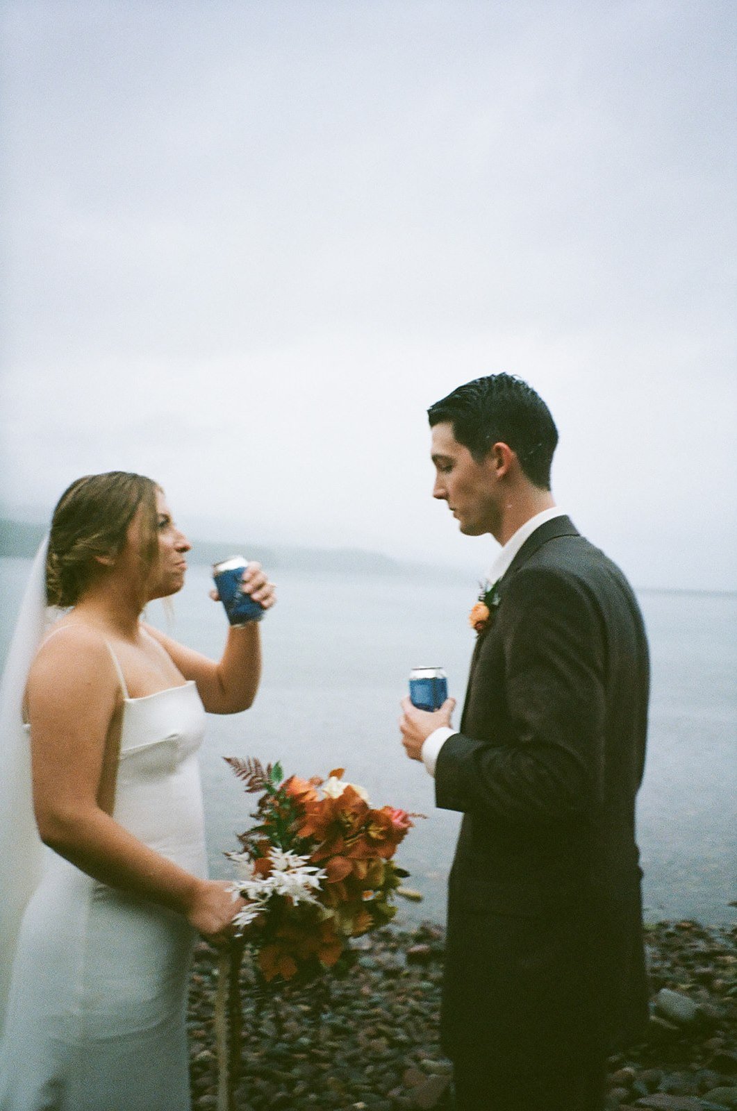 Film photos of bride and groom toasting with beer