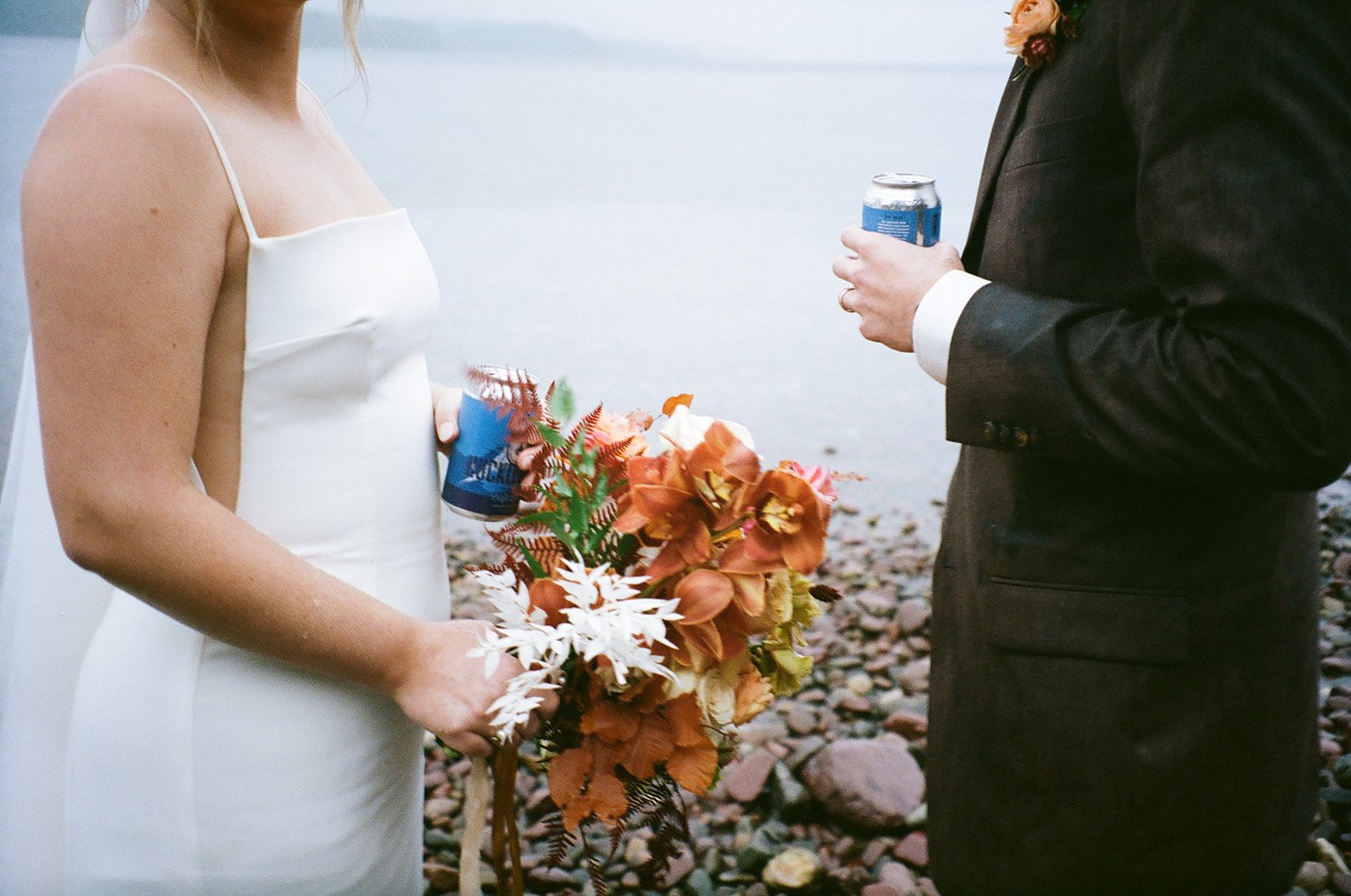Film photos of bride and groom toasting with beer