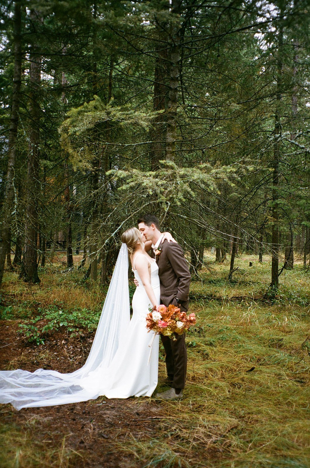Film photos of bride and groom kissing in national park