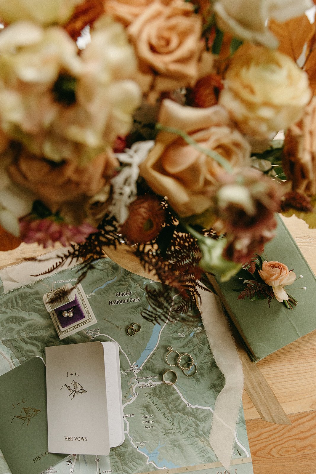 Bridal bouquet, vow books, and wedding rings