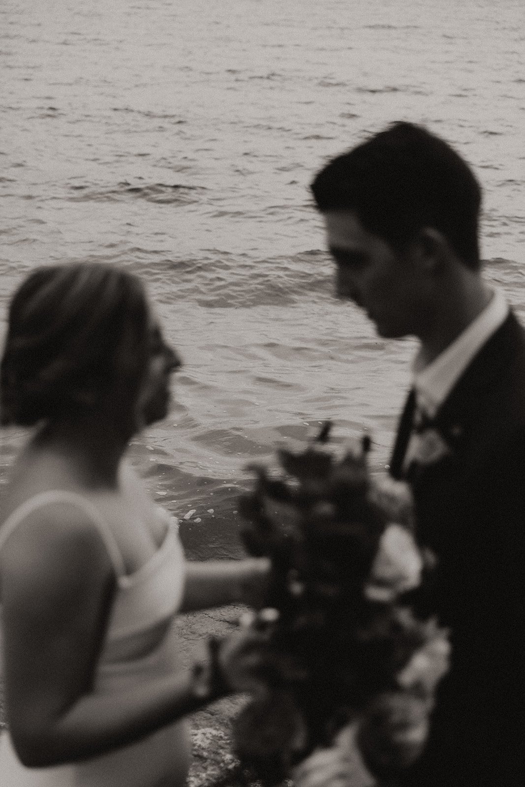 Black and white photo of bride and groom exchanging vows
