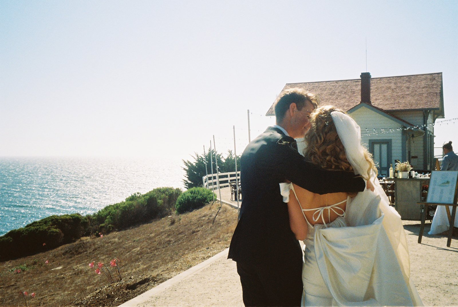 Bride and groom hugging on film