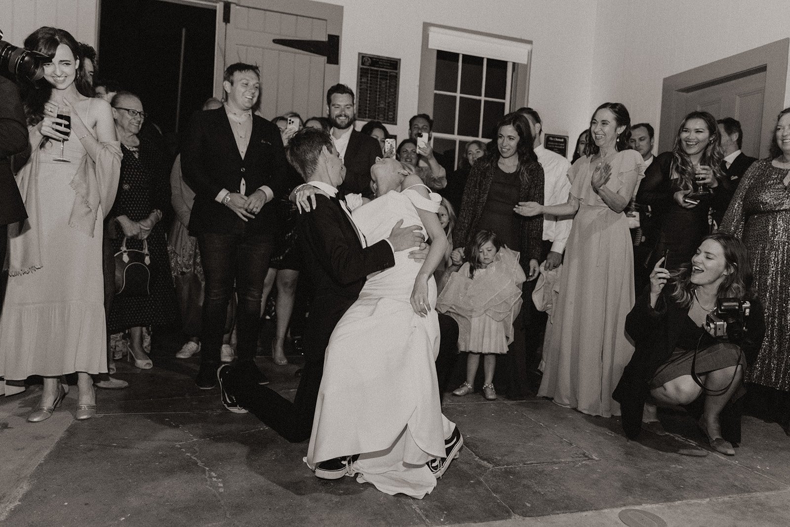 Bride and groom dancing on the dance floor during wedding reception in black and white