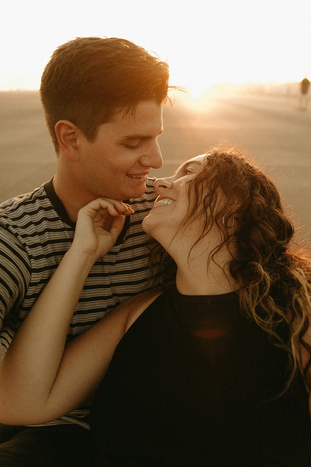 Newport Beach engagement photo session with cute couple during golden hour