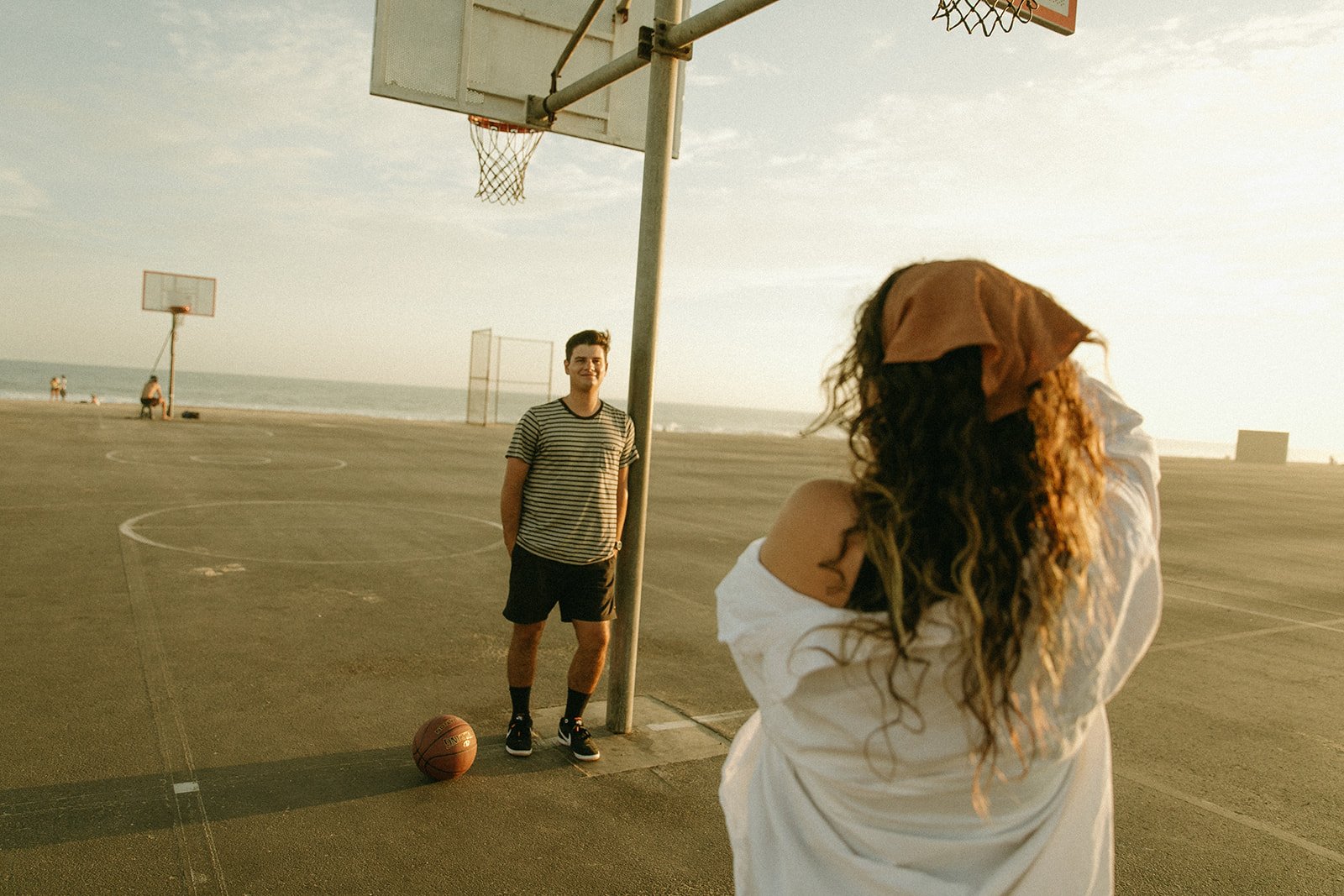 Newport Beach Engagement photo session on the beach during sunset on a basketball court