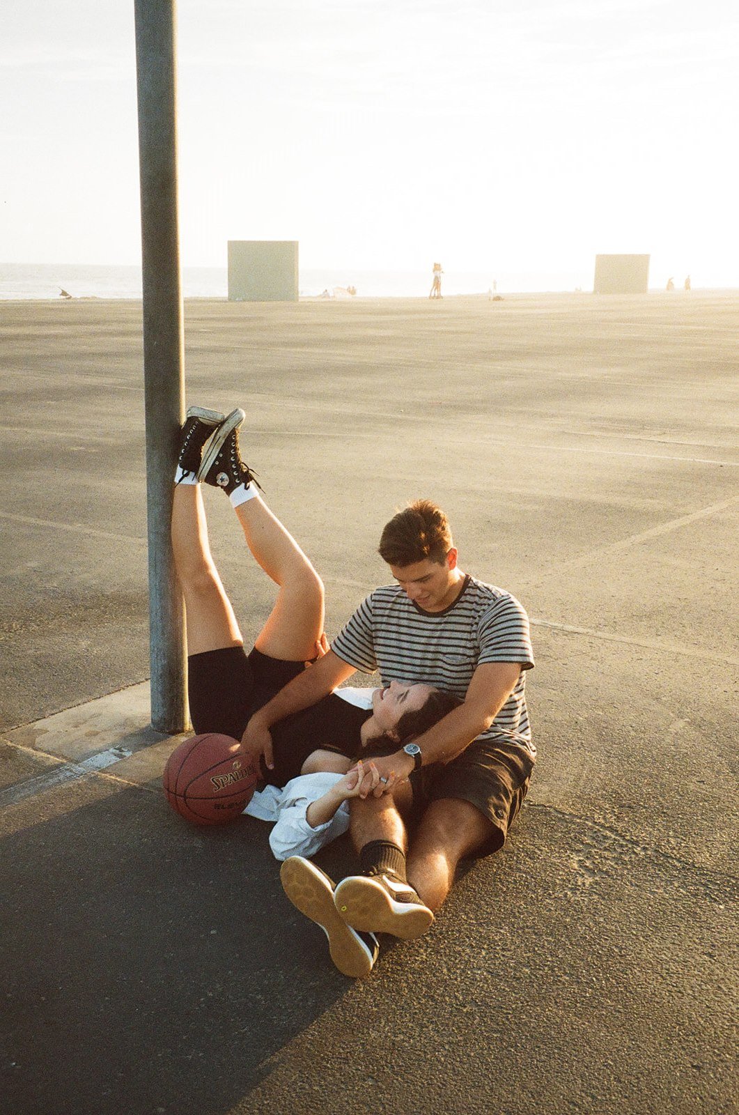 Newport Beach engagement photo session with couple at a basketball court on film