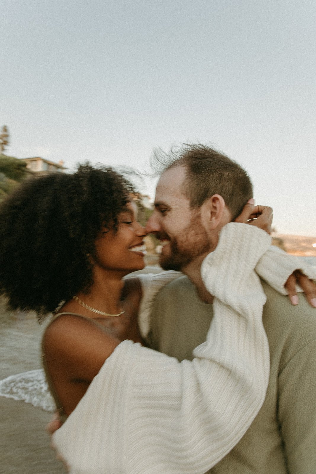 Adventure Couples Session with dreamy backdrops of beach waves in Laguna Beach