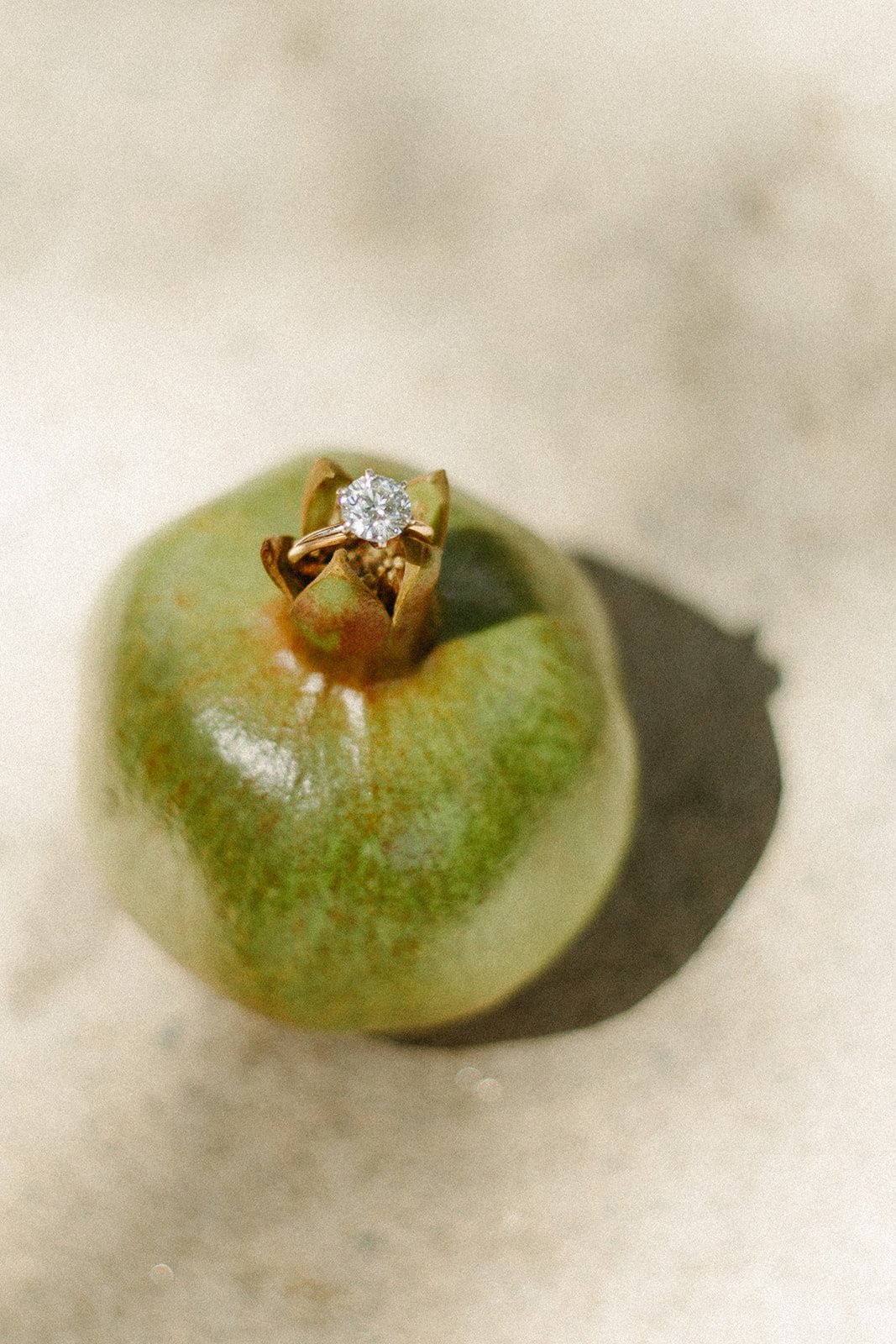 Wedding ring on green pomegranate