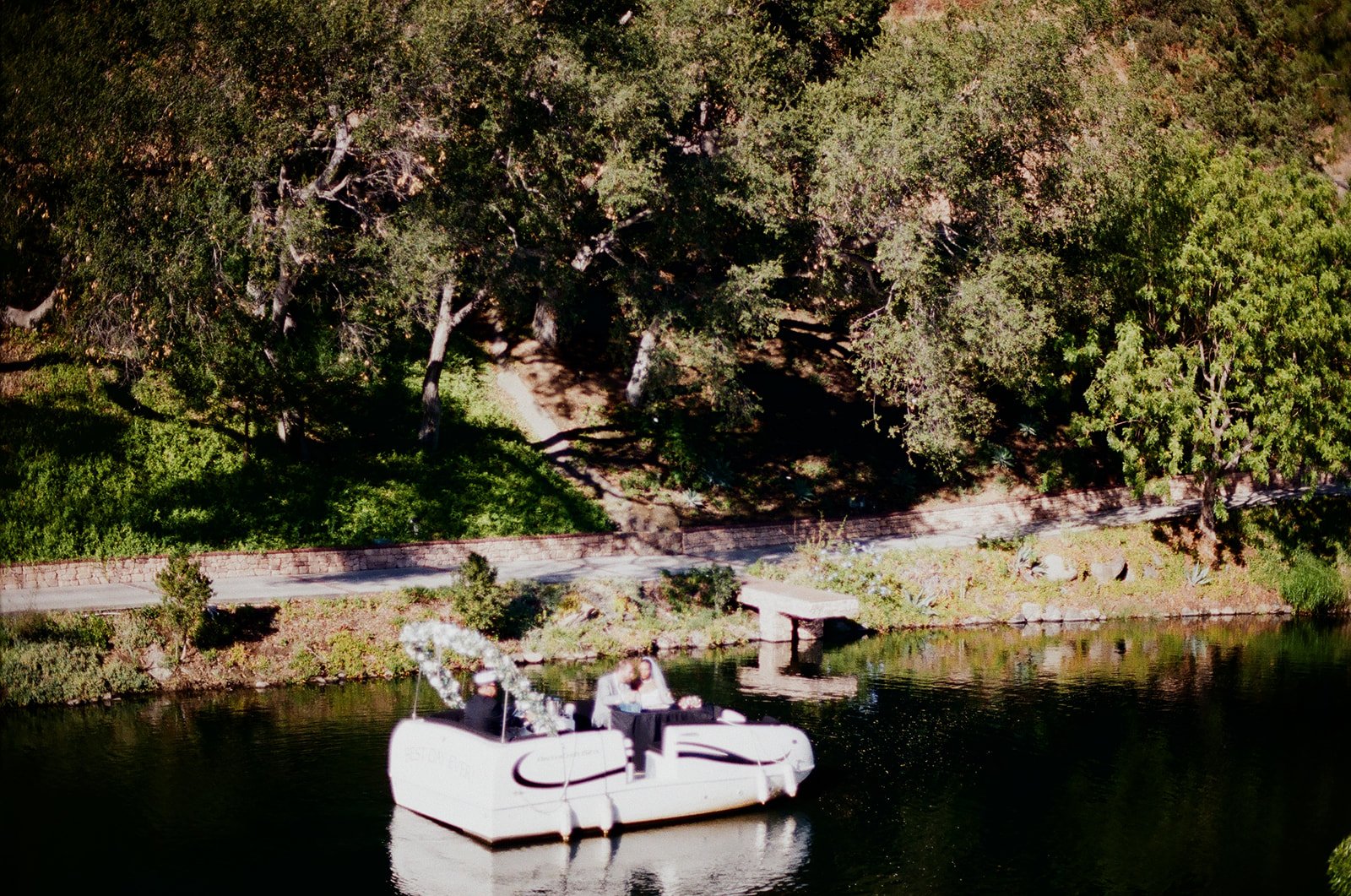 Film photo of bride and groom in a boat