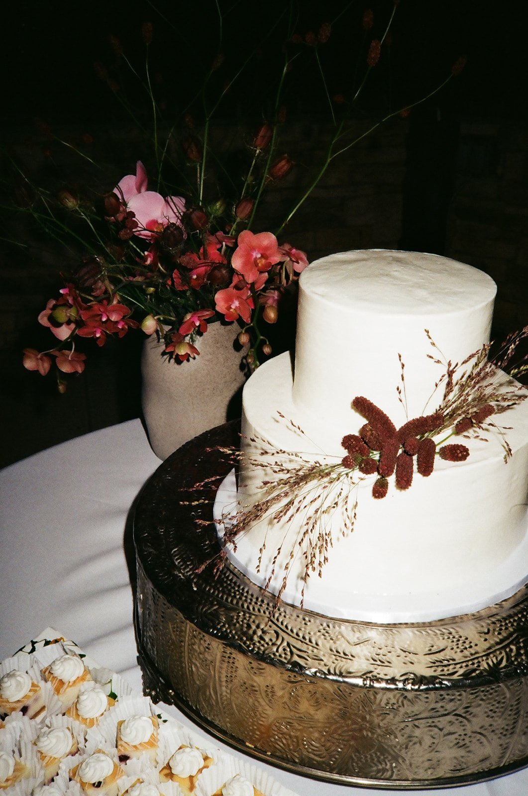 Film photo of white wedding cake and florals