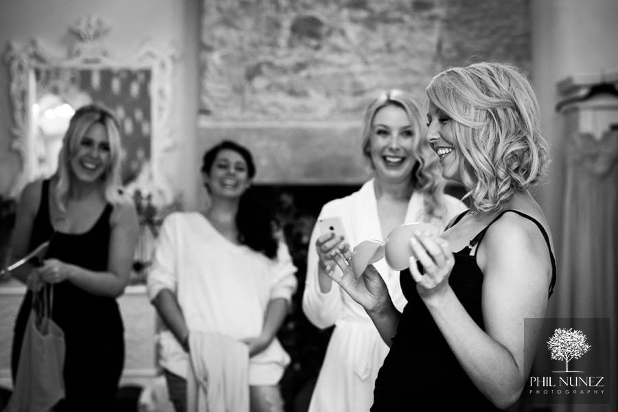 Bridesmaids sharing a joke together during the bridal preparations at a Woodhill Hall wedding.