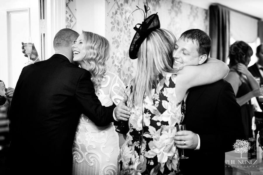 Lots of warm wishes and hugs being exchanged immediately after a wedding ceremony at Woodhill Hall.