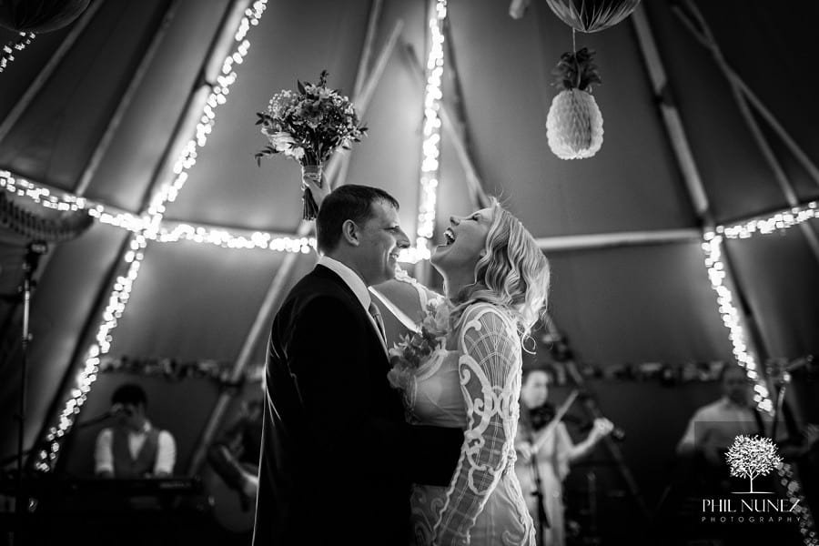 A bride and groom share their first dance together in a tipi at Woodhall Hall in Northumberland.