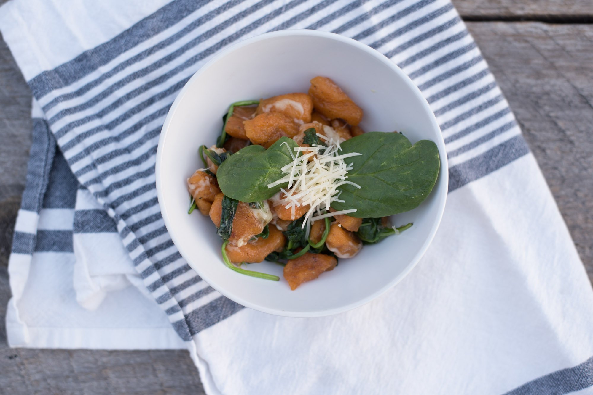 Delicious Paleo homemade Sweet Potato Gnocchi with a garlic butter spinach sauce