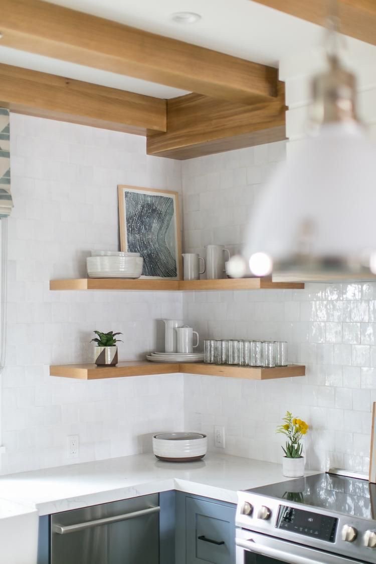 The Wild Decoelis |  Our Kitchen Tile |  White Mallorca tile by Centura in a 4x4 square with white grout in kitchen with floating shelves