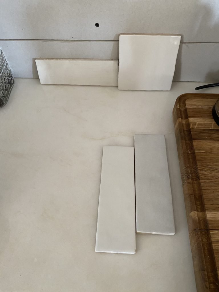 The Wild Decoelis |  Our Kitchen Tile |  White Mallorca tile by Centura in a 4x4 square with white grout in kitchen with floating shelves zellige tile, Fes tile