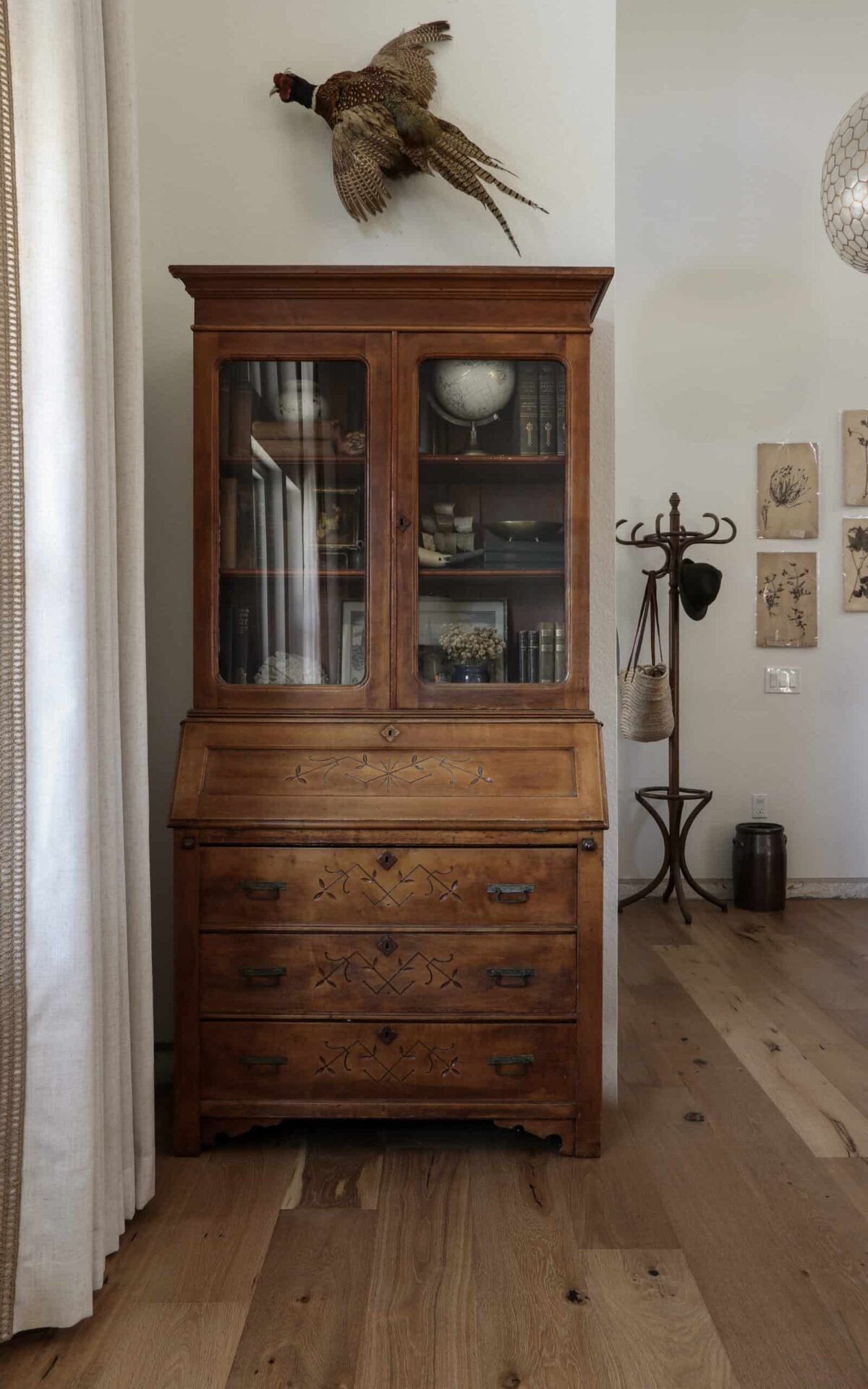 antique secretary desk in a living room with hardwood floors