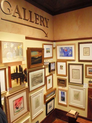 Entrance to the lower level gallery has art displayed in salon style.jpg