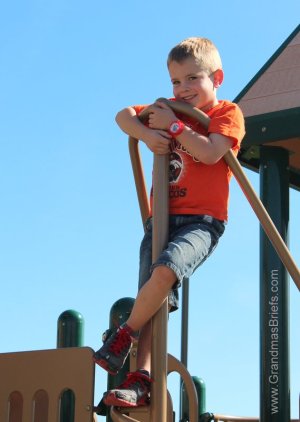 child on park play structure
