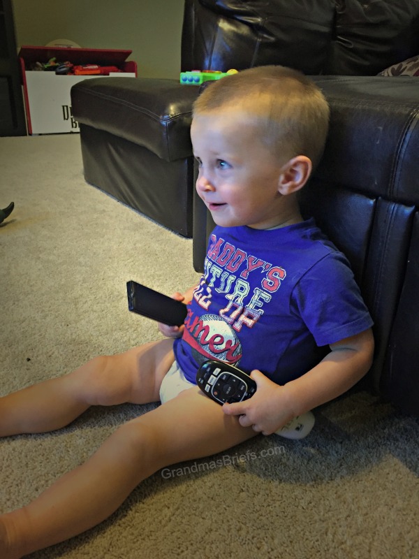 toddler boy with remotes