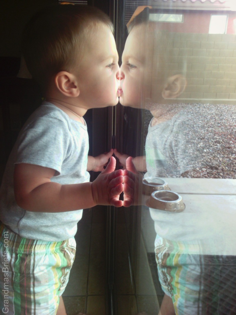 toddler reflection in door
