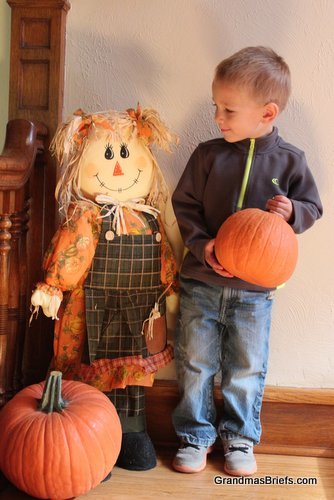 toddler and scarecrow