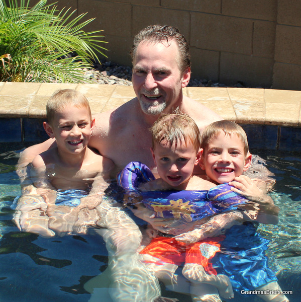 grandfather and grandsons in hot tub