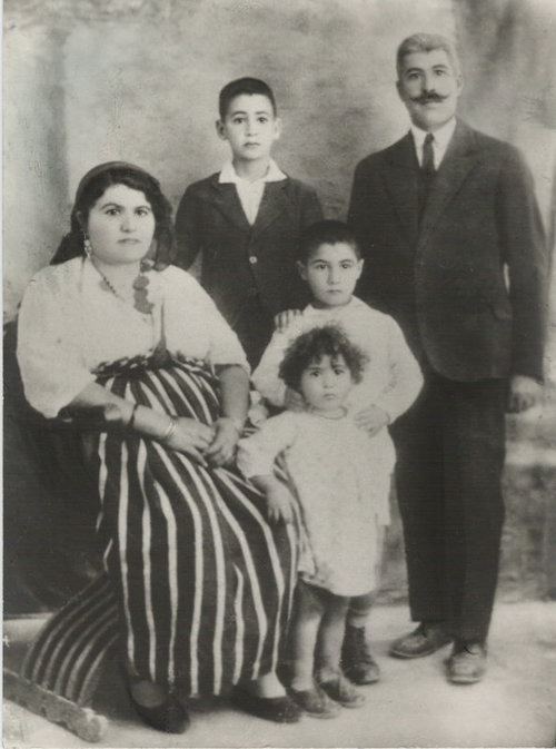 Click photo to download. Caption: Prof. Maurice Roumani's grandparents and other family members from Libya, pictured in the late 1920s. Members of Roumani's extended family in Libya endured everything from expulsions, to a 1,200-mile trek through the Saharan desert, to deportations to the Bergen-Belsen concentration camp. Credit: Courtesy Prof. Maurice Roumani.