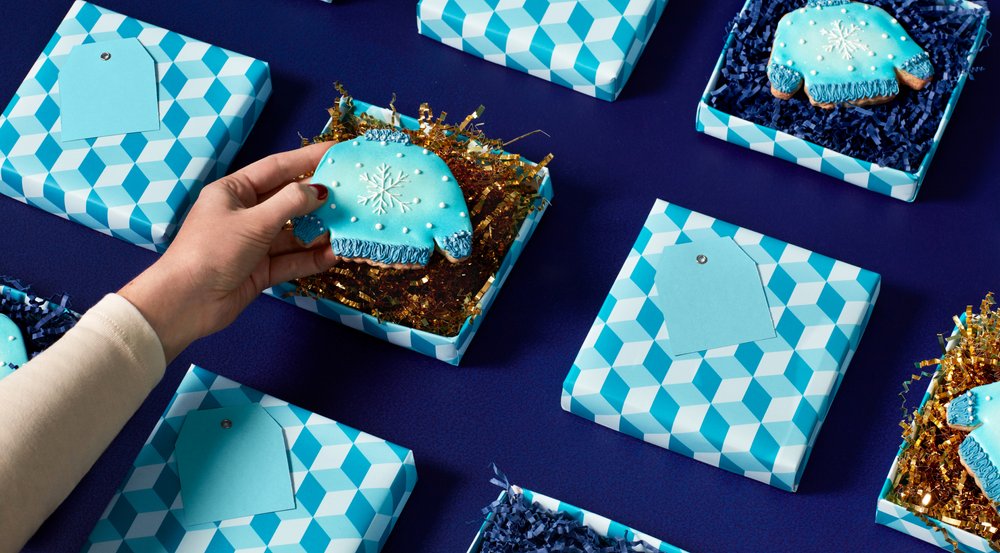 Sweater-shaped cookies in holiday gift boxes