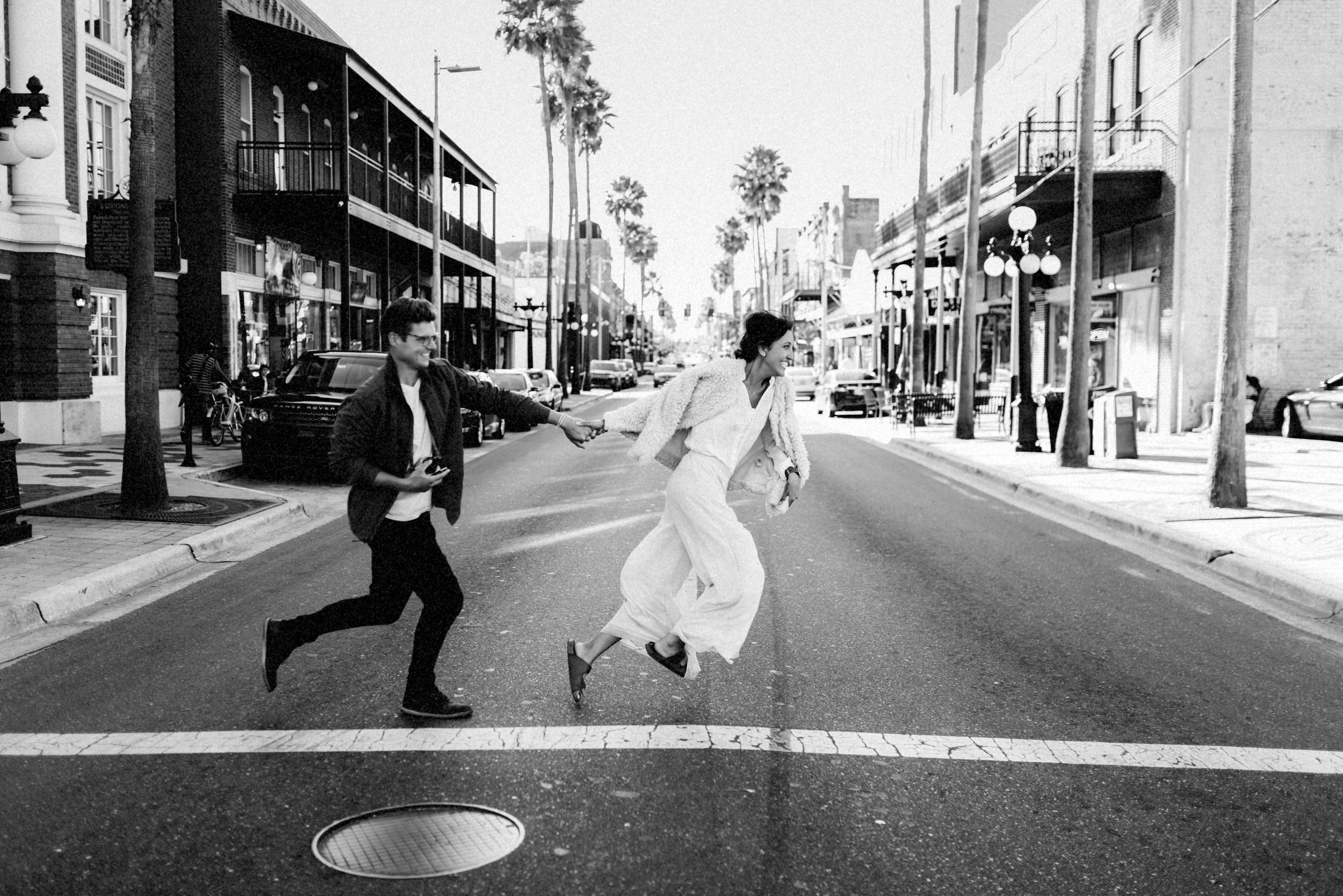 Brandon & Hillary running in Ybor Tampa Florida - couple portraits - st pete florida - naples florida wedding photographer - tampa wedding photographer