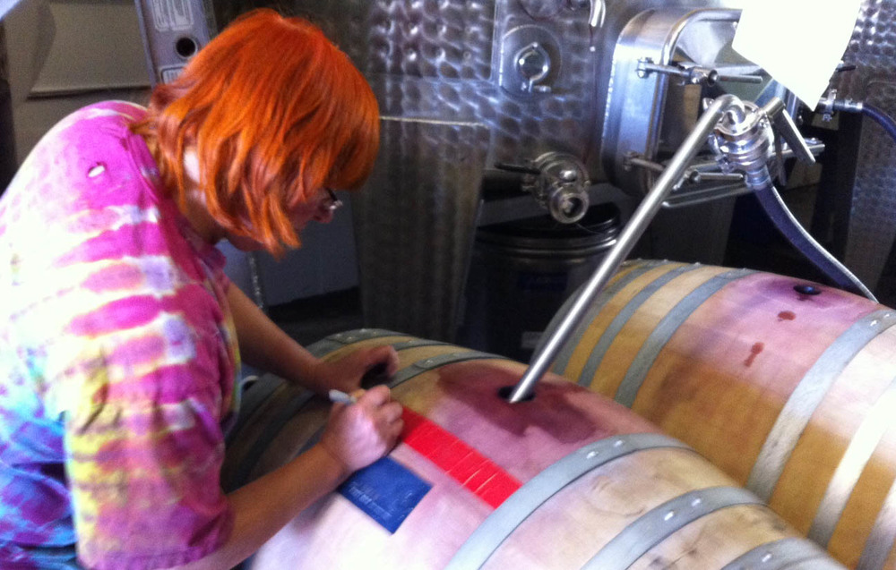 Lane tops up a barrel of 2013 Lumen Pinot Noir.