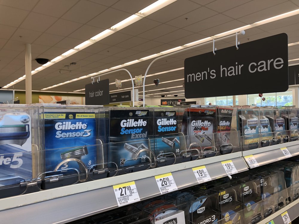  Men's hair care sign hung over the shaving section. 