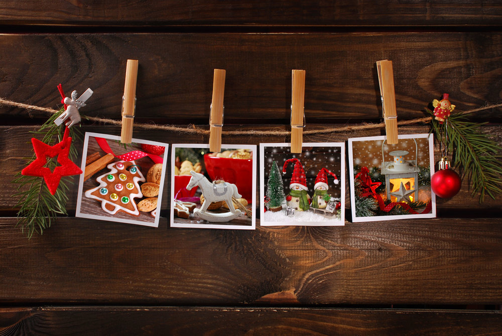  34365824 - four christmas  photos hanging on rope with bamboo clothespins against old wooden background 