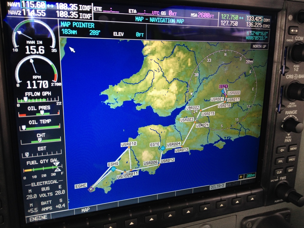  The flight plan from Oxford to Newquay and back via Exeter and Lands End, which we loaded manually into the Cessna's navigation system during our pre-flight planning. This screen, the MFD, shows an overview of the flight plan, as well as displaying critical engine parameters on the left, and communication/radio aid frequencies along the top. 