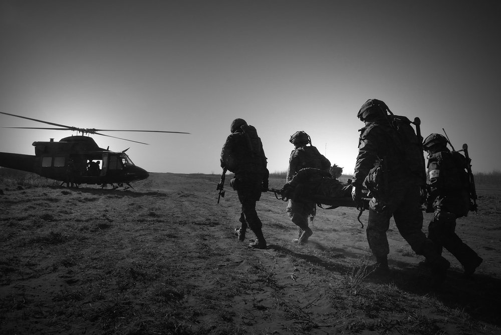  An injured soldier is rushed off the battlefield and onto a CH-146 Griffon helicopter following a firefight in a mock Afghan village during Exercise MAPLE GUARDIAN at CFB Wainright in 2008. Unfortunately, this scenario played out all too often on the real battlefield of Afghanistan. (Cpl Jasper Schwartz, Army News Montreal) 