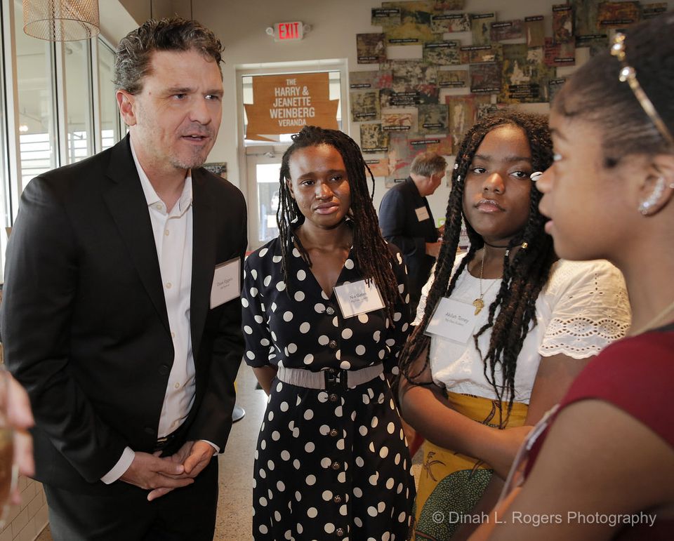  Author Dave Eggers chats with students Nia Gates, Akilah Toney and Amaya Smith at a benefit for New Orleans's Youth Writing Center Thursday (May 18) at the Goldring Center for Culinary Medicine. (Dinah Rogers Photo) 