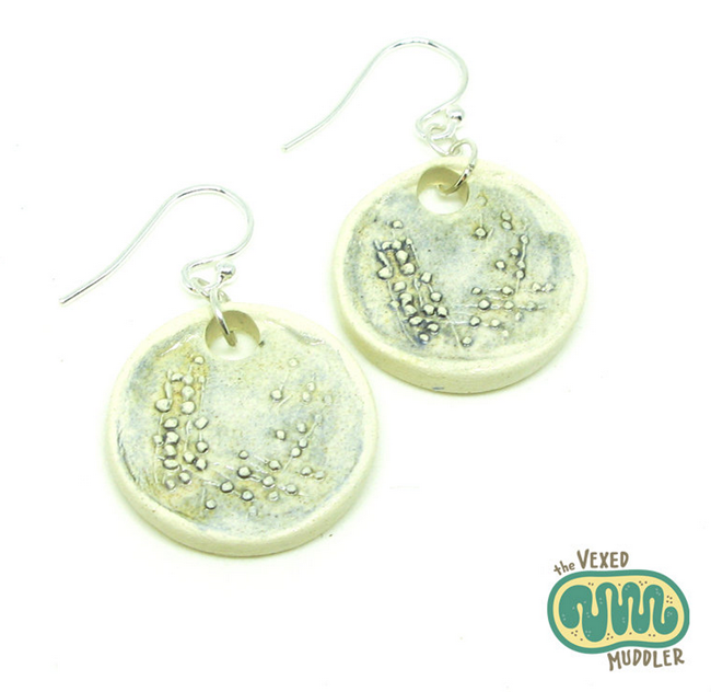 These Petri dish earrings are handcrafted and hand painted to resemble a bacterial culture streaked out on a petri plate.