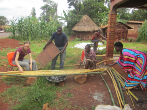Laurel, Brian and women from the village help roast the bamboo poles