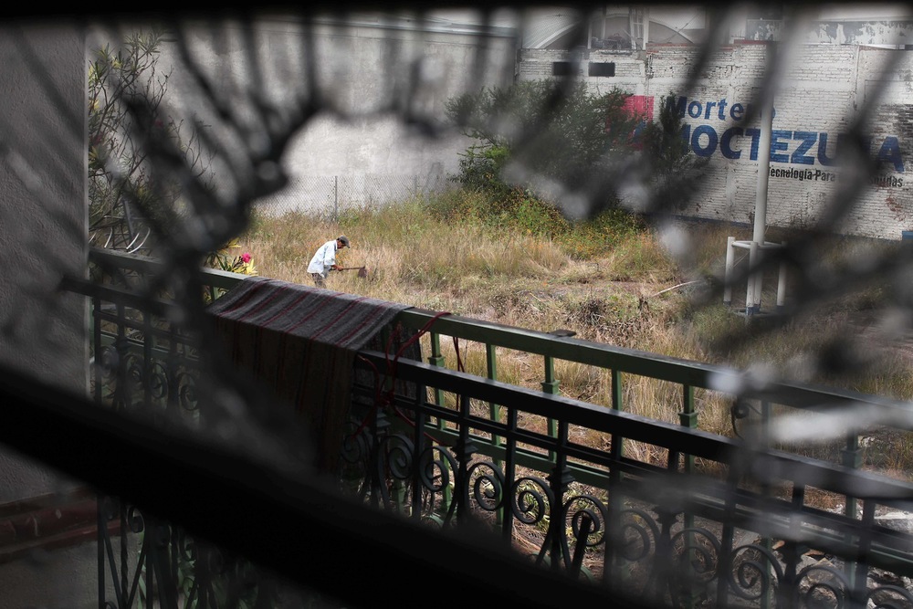  &nbsp;A farmer is seen tilling the land through a broken window in the town of San Juan Del Río 