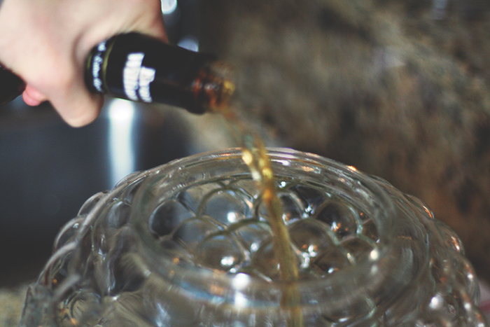Pour in 1 bottle of whiskey. You'll want to use a low to medium grade (you don't want to mess with the good stuff!)