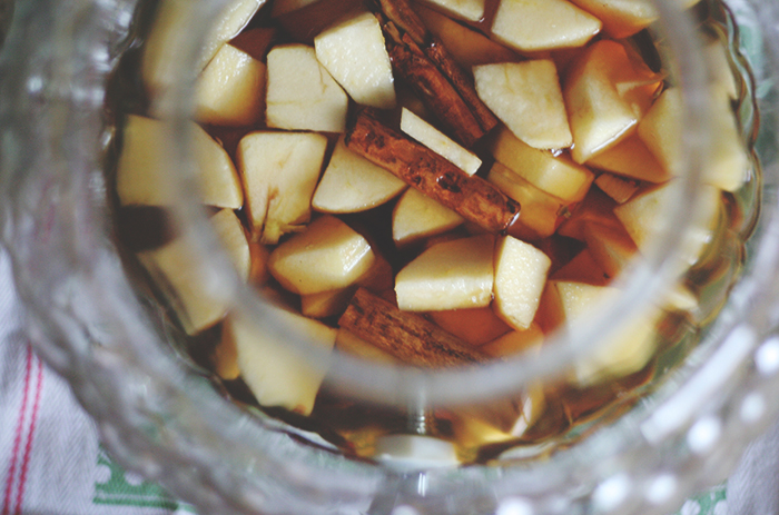 Drop in the chopped apples. Finish off with a few more cinnamon sticks, stirring well to ensure apples and cinnamon sticks are completely covered in the whiskey. 